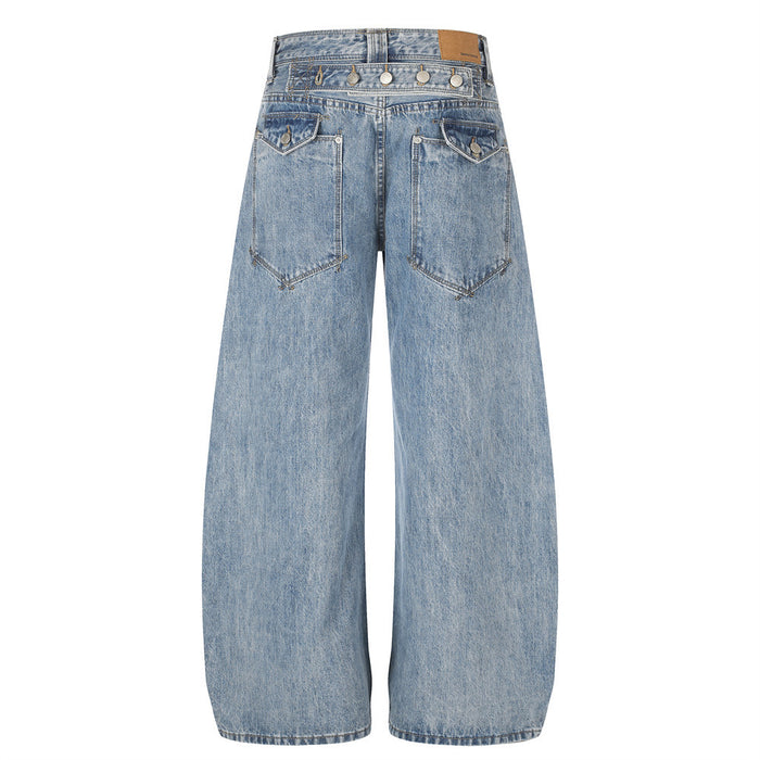 Back view of light blue washed denim jeans with two angular patch pockets and wide barrel legs