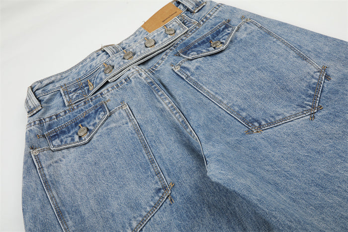Laid-flat back view of light blue washed jeans showing the waistband, rear pockets, and contrast stitching