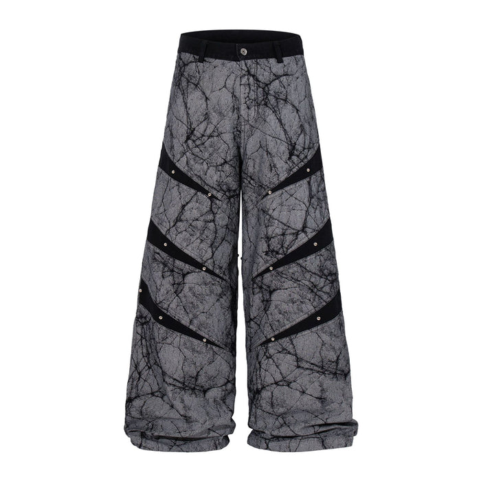 Grey crackle-print wide-leg baggy jeans with diagonal black studded stripe panels, front and back view