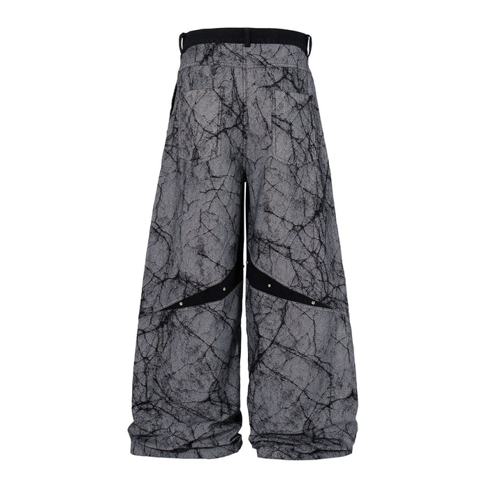 Back view of gray wide-leg jeans featuring a black crackle print and diagonal striped detail