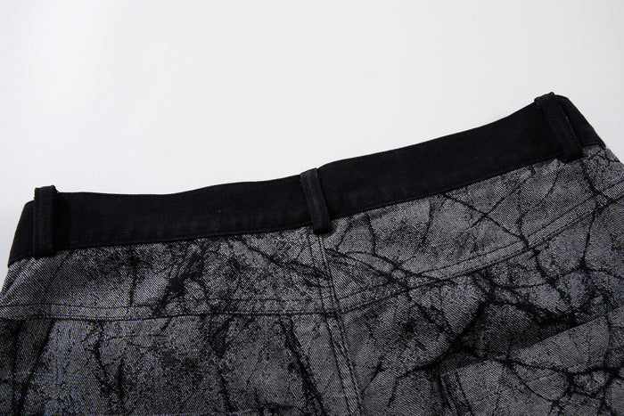Close-up of the back waistband and belt loops on gray crackle-print wide-leg jeans