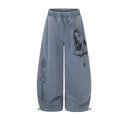 Washed blue wide-leg sweatpants with black gothic portrait and script prints on the front