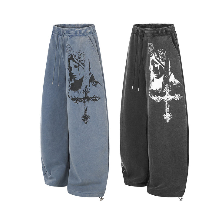 Washed blue and black wide-leg sweatpants displayed together with contrasting gothic portrait prints