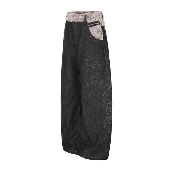 Angled front-side view of black wide-leg jeans showing a zippered pocket, faux fur waistband and tonal leg motifs