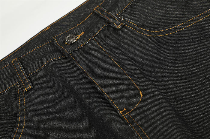 Detailed view of the jeans fly, button closure, belt loops, and orange-stitched front pocket seams