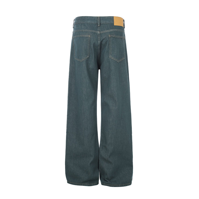 Full back view of teal green wide-leg jeans with two stitched patch pockets and a tan waistband label