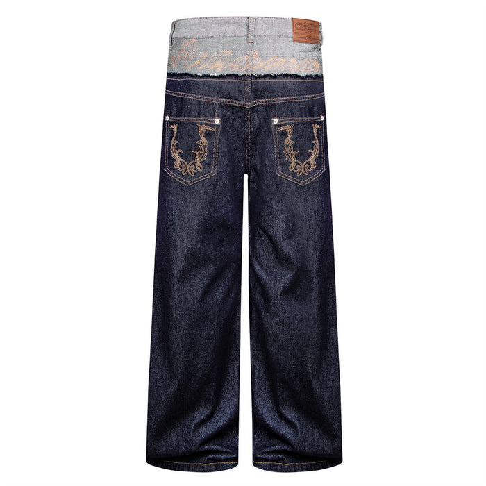 Back view of wide-leg raw denim jeans with gray double waistband and ornate embroidered back pockets