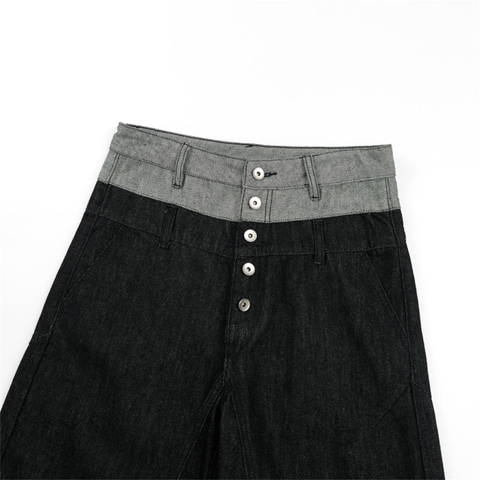 Close-up of the jeans front showing the gray waistband, belt loops, stitching, and button fly