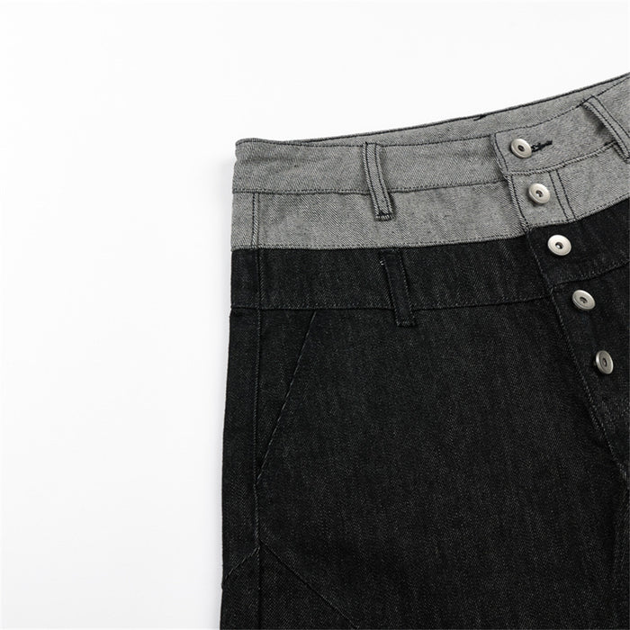 Front side detail of black wide-leg jeans showing the gray waistband, belt loop, pocket seam, and button fly