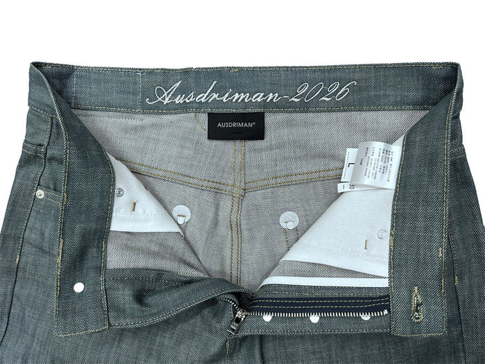 Inside view of lake green jeans showing the waistband label, pocket lining, zipper closure, and button fly