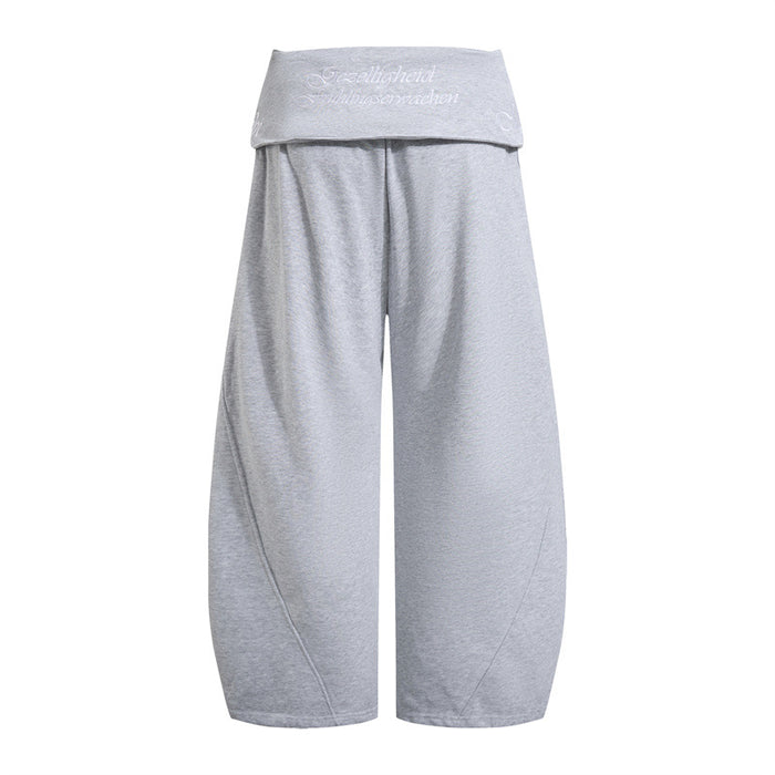 Light gray wide-leg pants shown from the back with a fold-over waistband and white embroidered lettering