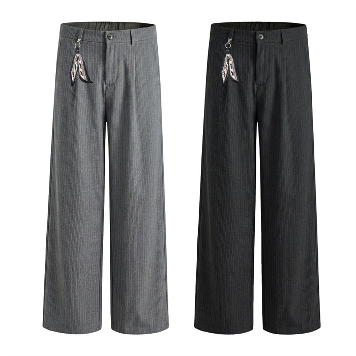 Men's wide-leg pinstripe trousers in black with pleated front, chain clip accent, and straight-cut silhouette