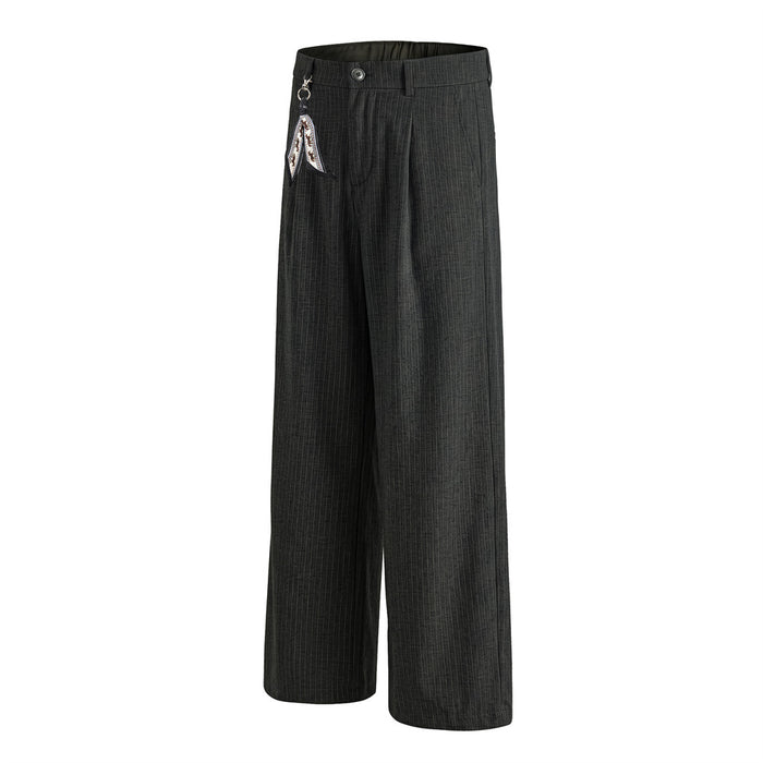 Angled front view of black pinstripe trousers showing the wide straight-cut legs and pleated waistband