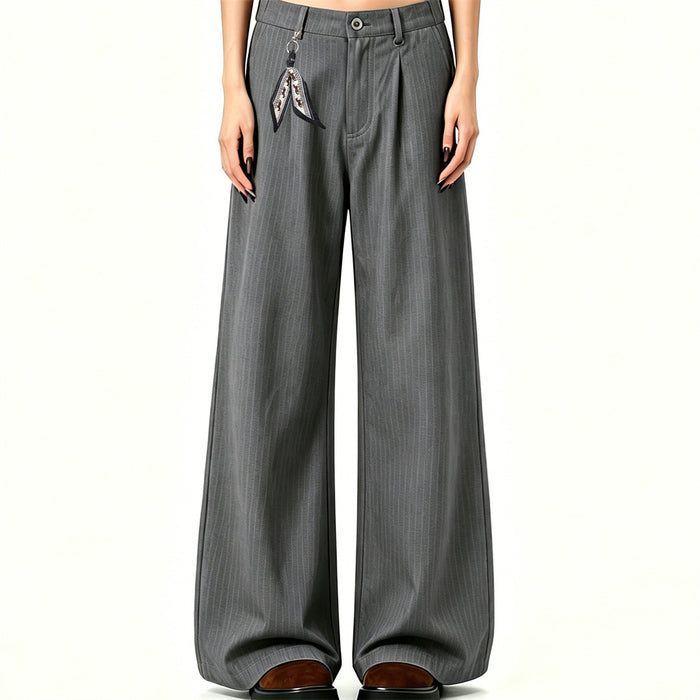 Front view of gray pinstripe wide-leg trousers worn with pleats, wide legs and a patterned side charm