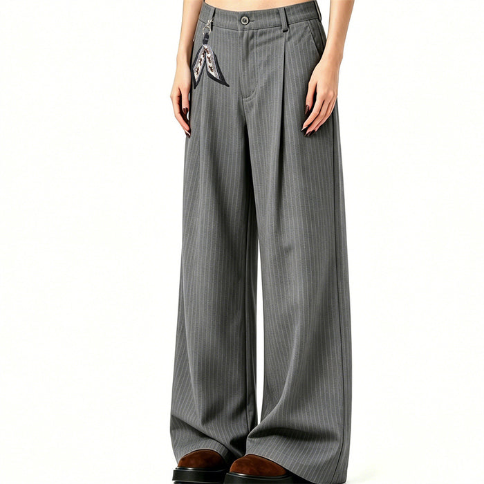 Angled model view of gray pinstripe trousers showing the pleated front and flowing wide-leg silhouette