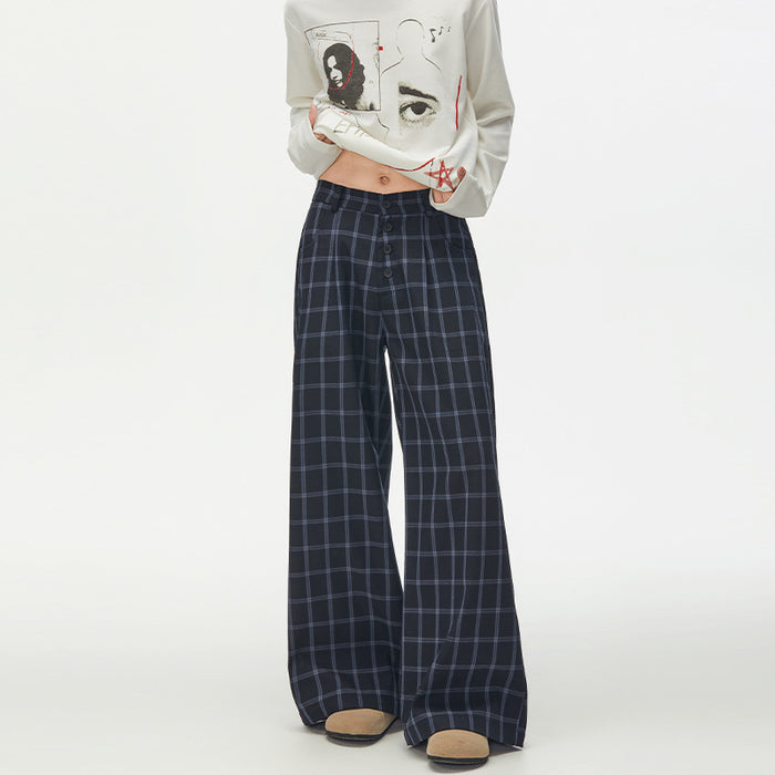 Model wearing navy wide-leg trousers with a light blue plaid pattern and button-front waist