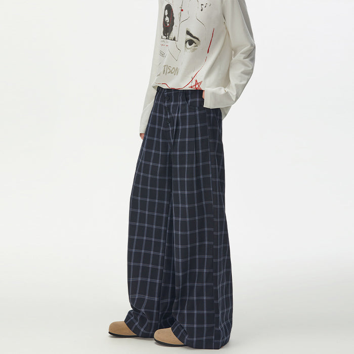 Three-quarter view of navy plaid wide-leg trousers showing the relaxed fit and side pocket