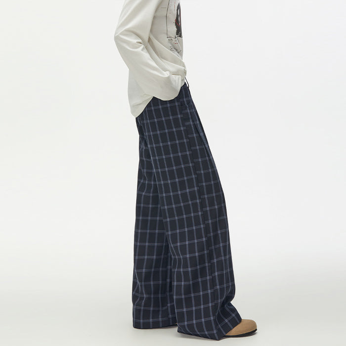 Side view of navy check wide-leg trousers with a flowing relaxed silhouette