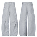 Men's wide-leg blue and white pinstripe trousers with deconstructed multi-directional stripe panels and high waist, front and