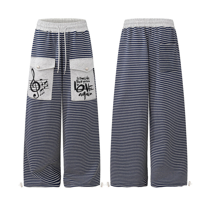 Front and back views of navy and white striped wide-leg sweatpants with gray cargo pockets and music graphics