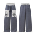 Front and back views of navy and white striped wide-leg sweatpants with gray cargo pockets and music graphics