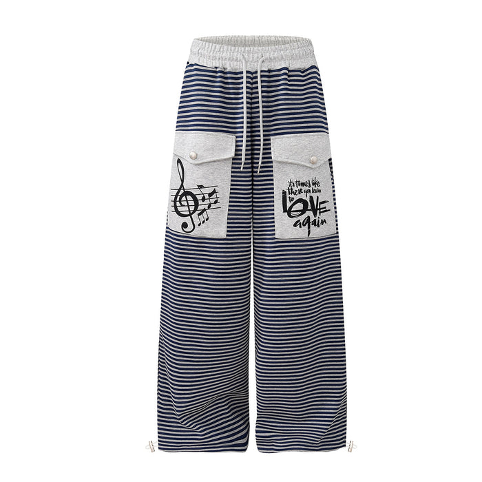 Wide-leg navy and grey striped sweatpants with music note print cargo pockets and drawstring waist, front and back view