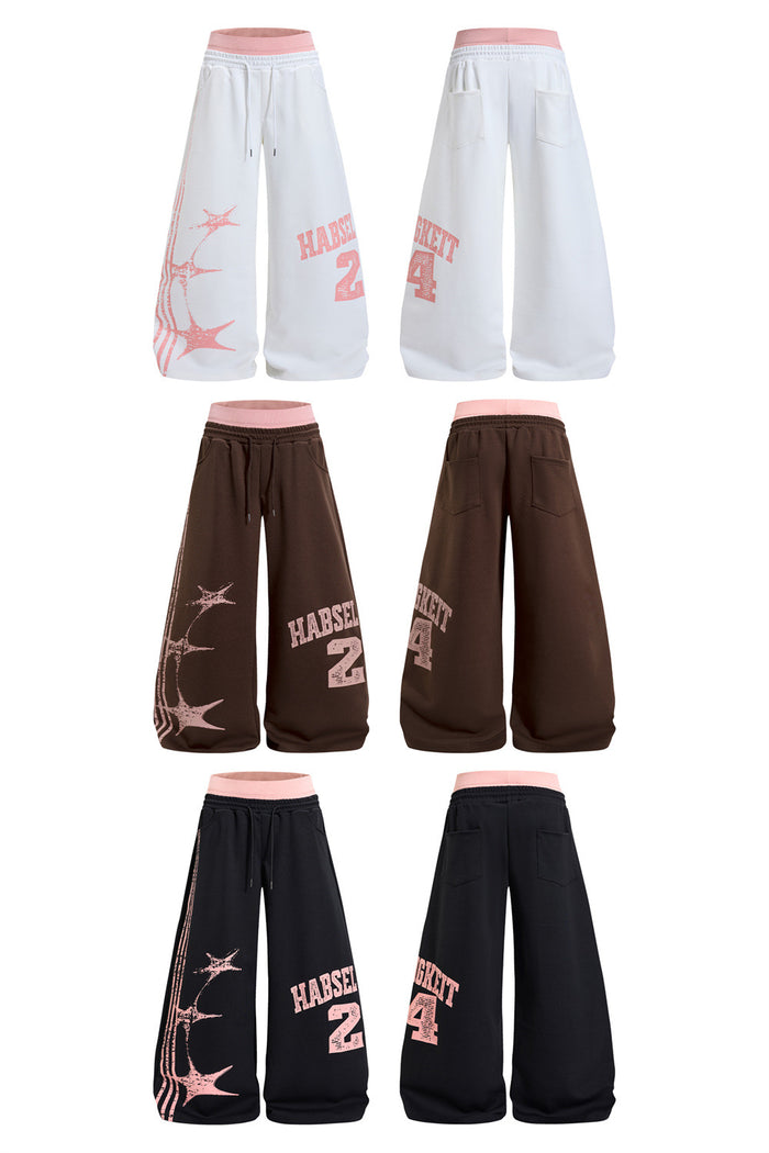 Front and back views of white, brown, and black wide-leg sweatpants with pink waistbands and printed designs