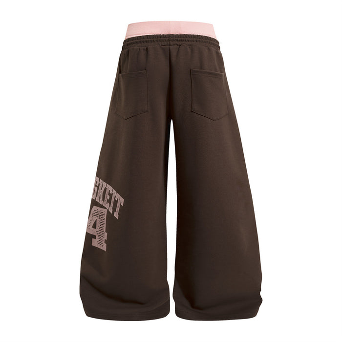 Back view of brown wide-leg sweatpants with two patch pockets and a distressed pink numbered graphic