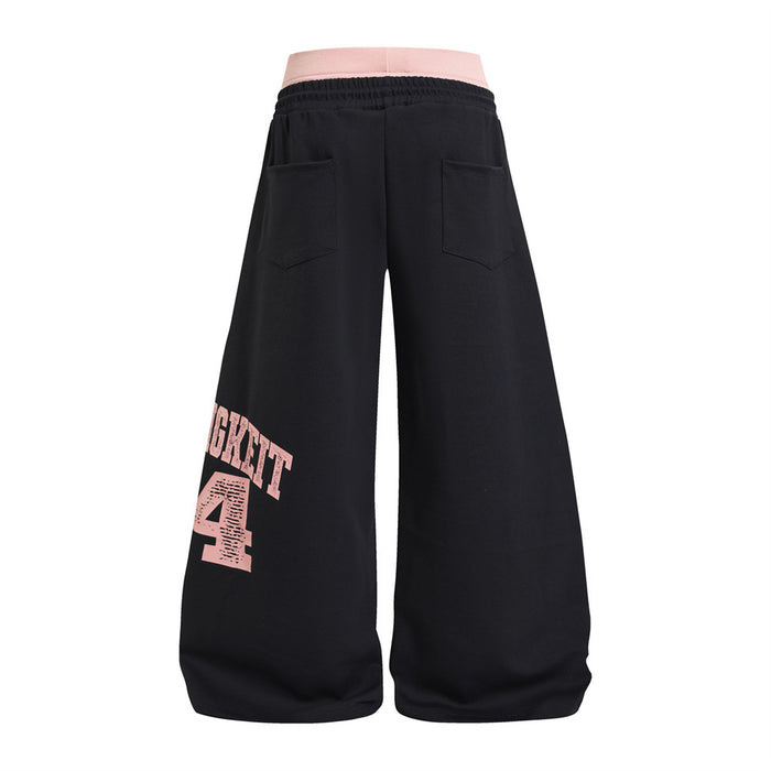 Back view of black wide-leg sweatpants with two patch pockets and a distressed pink numbered graphic