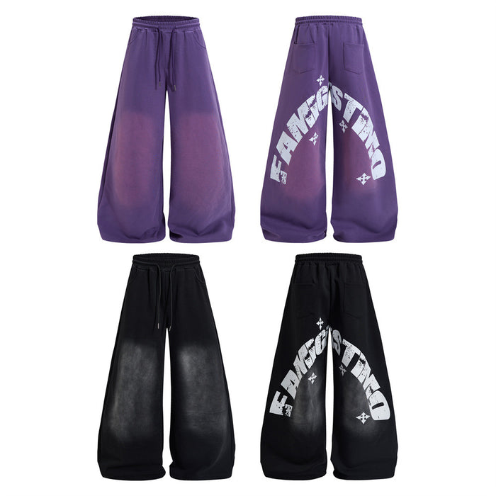 Oversized wide-leg sweatpants with distressed letter graphic print shown in deep purple and washed black colorways, front and