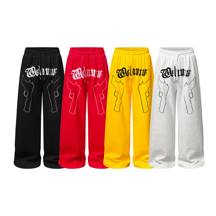 Front view of wide-leg sweatpants in black, red, yellow, and light gray with gothic lettering and dual gun outlines