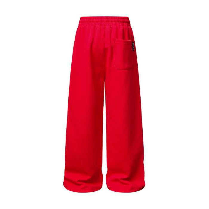 Back view of red wide-leg sweatpants with an elastic waistband and rectangular rear pocket