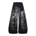 Black wide-leg sweatpants shown from the front with distressed gray star graphics and white Serendipity script