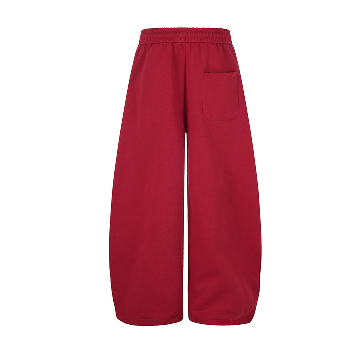 Back view of red wide-leg sweatpants showing the elastic waistband and single patch pocket