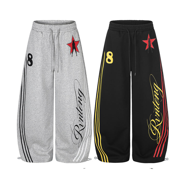 Gray and black wide-leg sweatpants shown together with star graphics, retro side stripes, numbers, and script prints