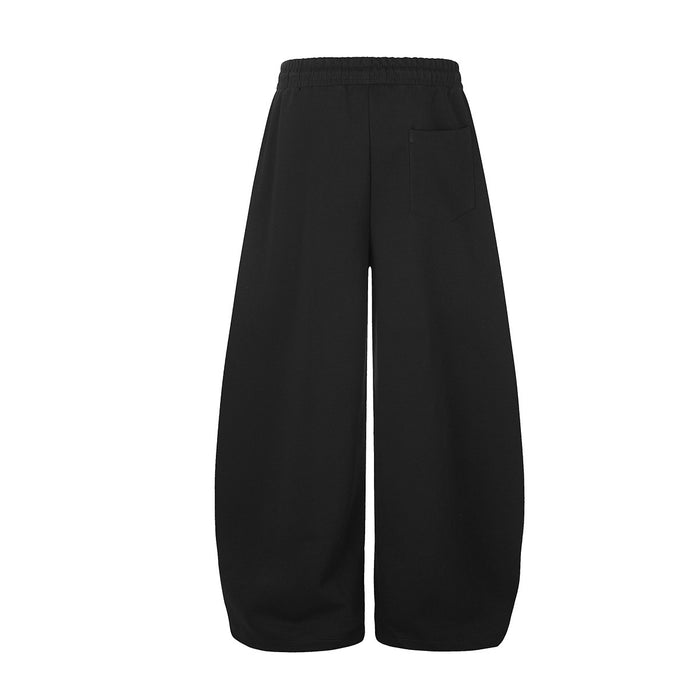 Back view of black wide-leg sweatpants with a plain design, elastic waistband, and rear pocket