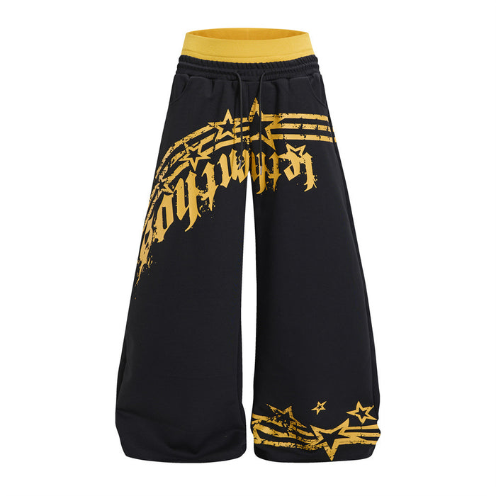Front view of black wide-leg sweatpants with a yellow waistband and distressed star graphic