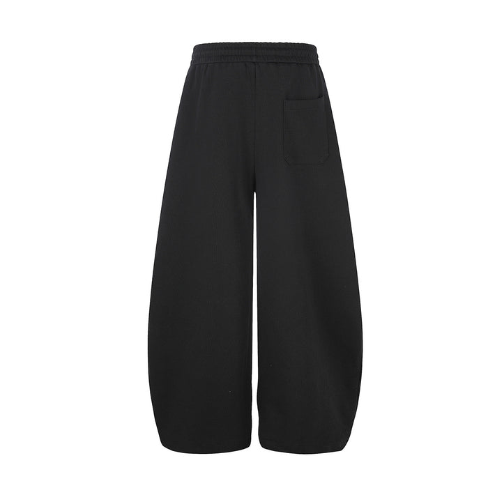 Back view of black wide-leg sweatpants with an elastic waistband and single rear pocket