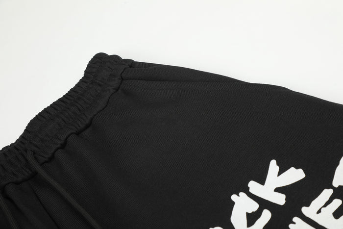 Close-up of the black elastic waistband and textured fabric on the wide-leg sweatpants