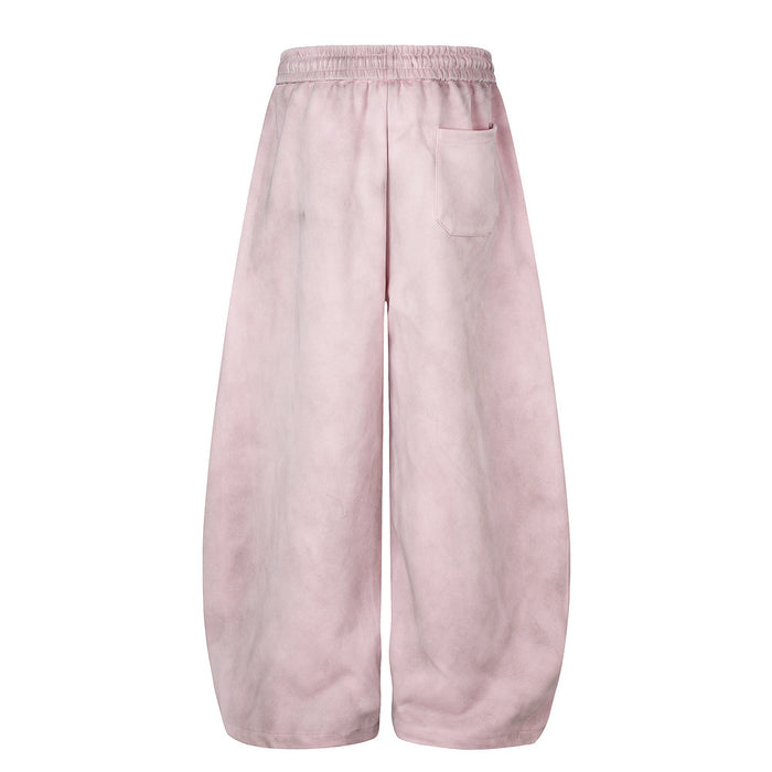 Back view of pink wide-leg velour sweatpants with an elastic waistband and rear pocket