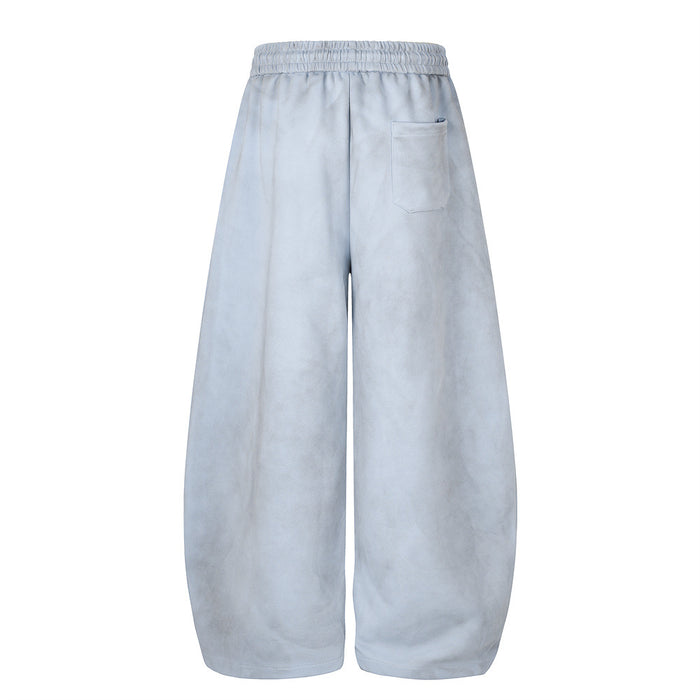Back view of light blue wide-leg velour sweatpants with an elastic waistband and rear pocket