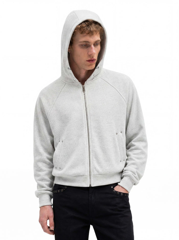 Ribbed zip-up cropped hoodie with raglan sleeves and silver hardware in heather grey, worn by male model with black jeans