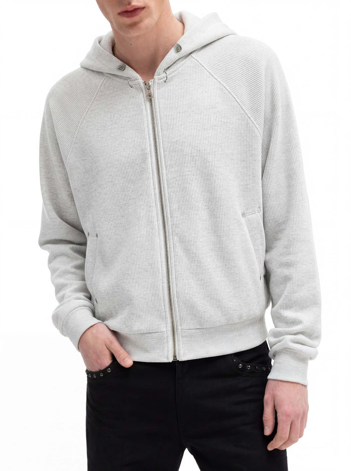 Light gray ribbed cropped zip-up hoodie worn open at the hood with raglan sleeves and front pockets