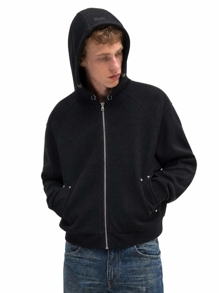 Black ribbed cropped zip-up hoodie worn with the hood up and hands in the front pockets