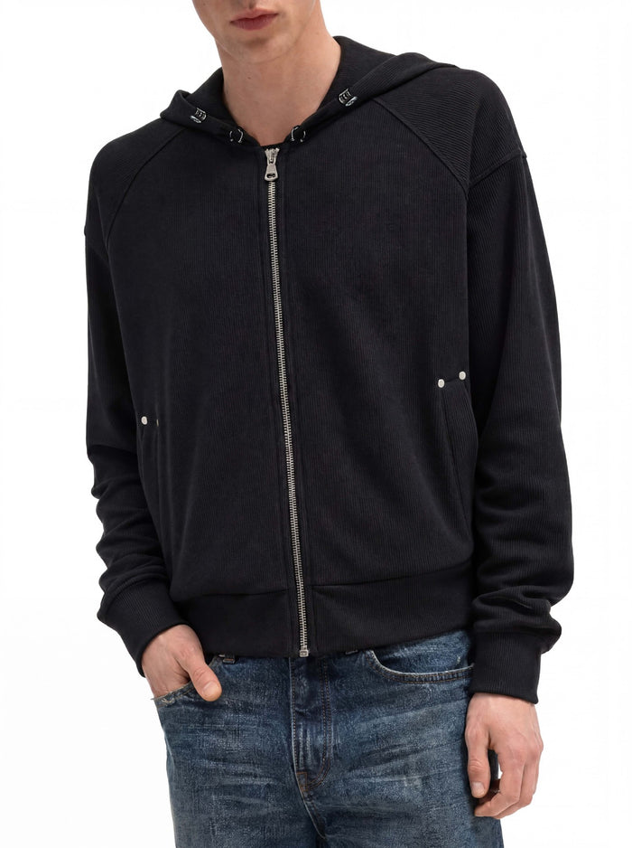 Close front view of a black cropped zip-up hoodie showing ribbed sleeves, hood, zipper and pockets