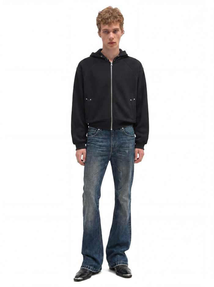 Black cropped full-zip hoodie worn from the front with the hood down and hands at the sides