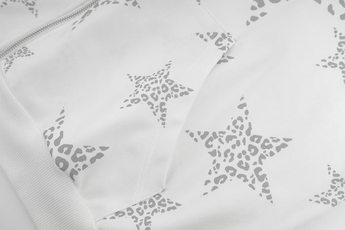 Close-up of gray leopard-pattern stars printed across the white hoodie fabric