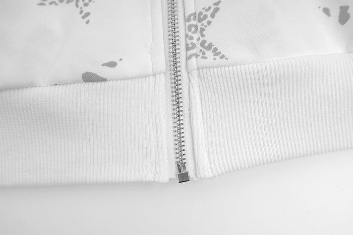 Close-up of the silver front zipper meeting the ribbed white waistband