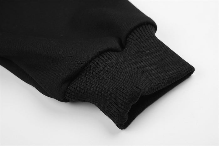 Close-up of a black hoodie sleeve cuff showing ribbed knit texture and stitched sleeve seam