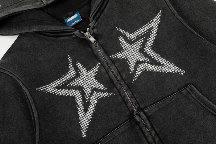 Close-up of the hoodie front showing twin rhinestone star graphics, central zipper, and kangaroo pocket seams
